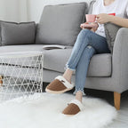 Pair of grey knitted slippers displayed on a clean white background.