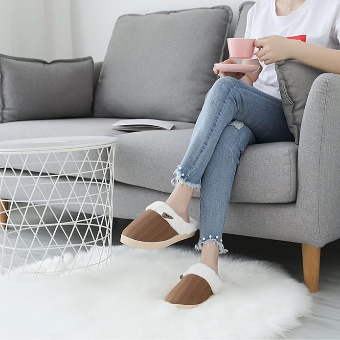 Pair of grey knitted slippers displayed on a clean white background.